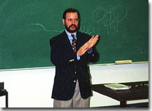 This is a picture of John Ellsworth giving a lecture to a University class.